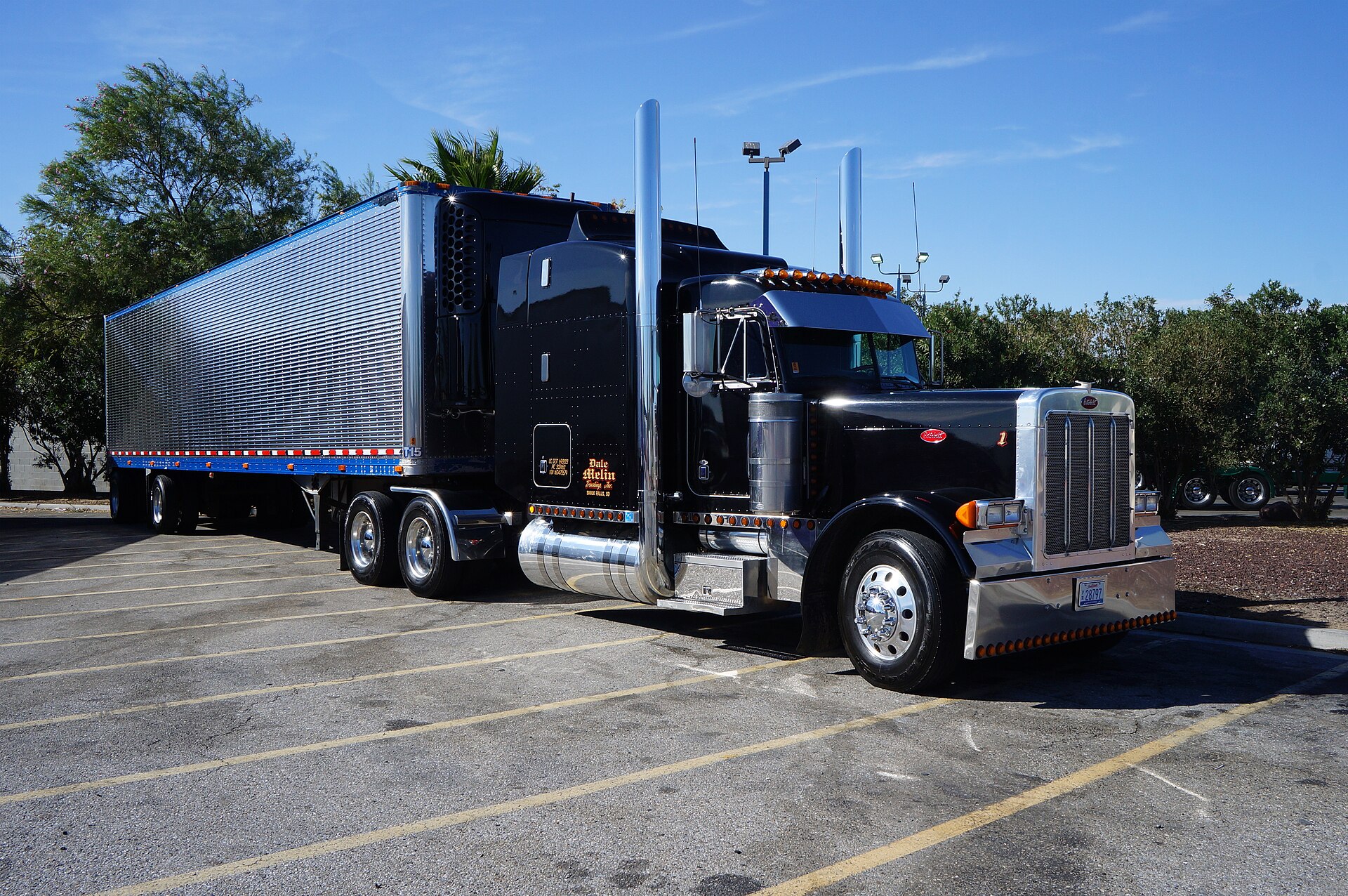 A black Peterbilt tractor parked at a Flying J Travel Plaza truck stop
