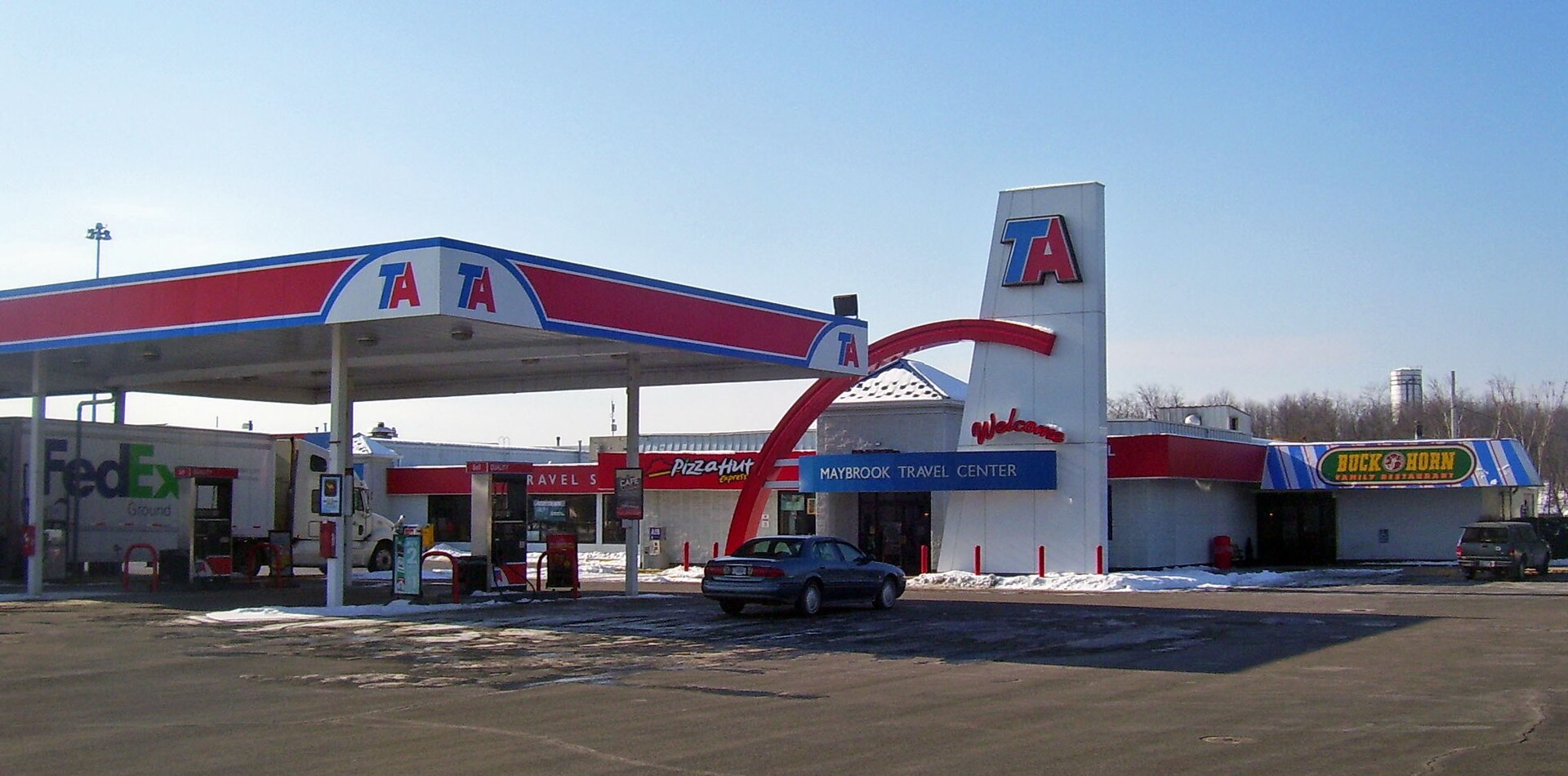 A TA Travel Center truck stop on a clear day, trailers parked on the lot